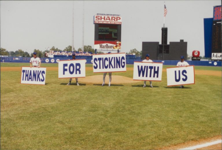 Mets Staff Hold Signs Saying 