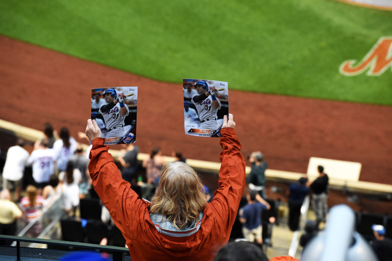 Fan Holding Two Photos of Mike Piazza in the Stands