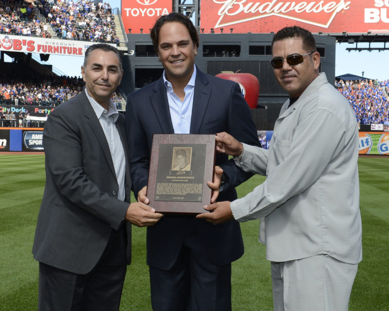 Photo of Mike Piazza With his Mets Hall of Fame Plaque