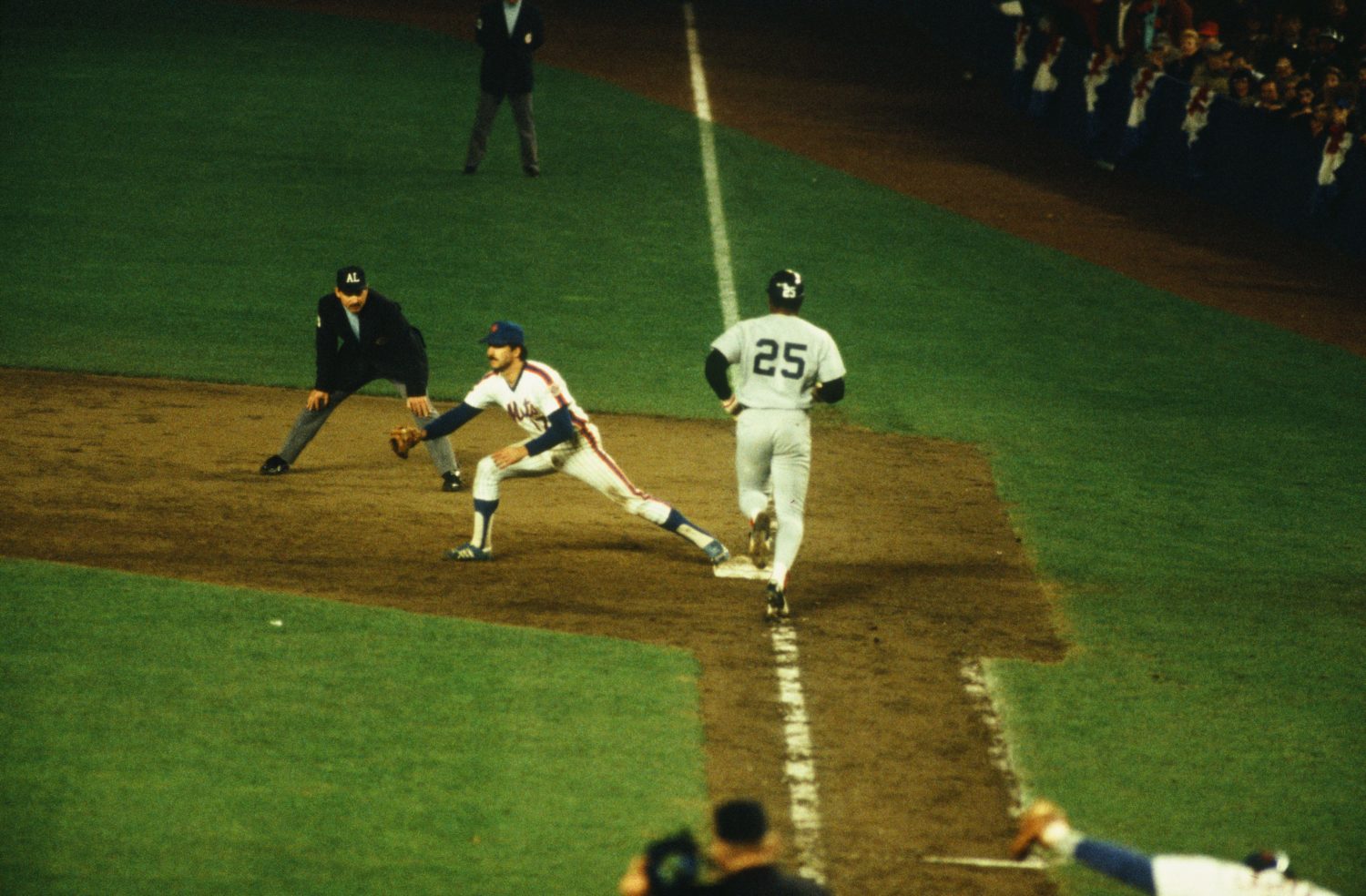 Keith Hernandez's stretches at first base to catch a ball as a runner touches the bag.