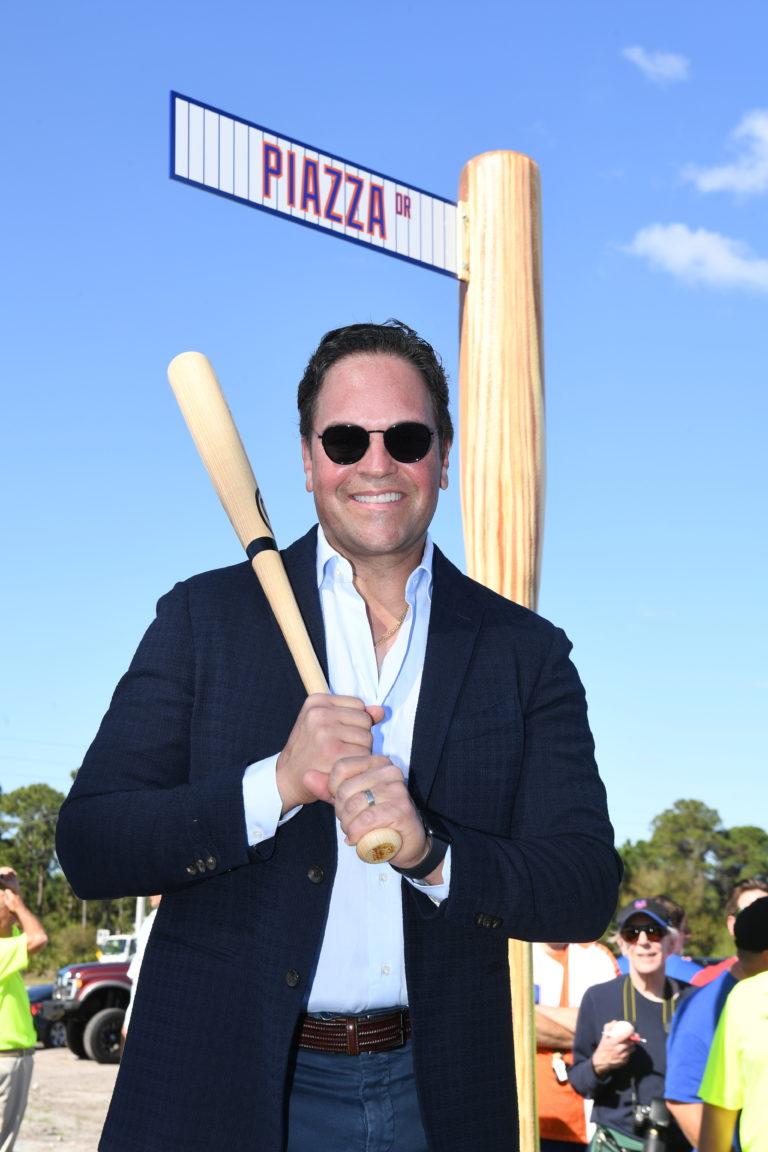 Mike Piazza Posing In Front of Streed Sign that Reads Piazza Dr