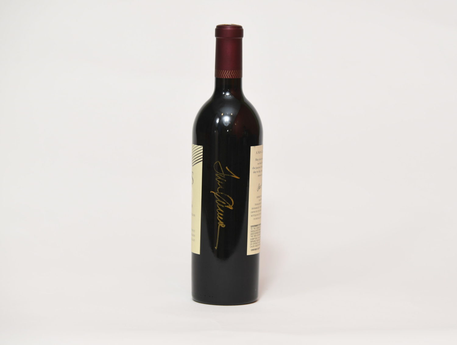 Back of wine bottle with signed name, 